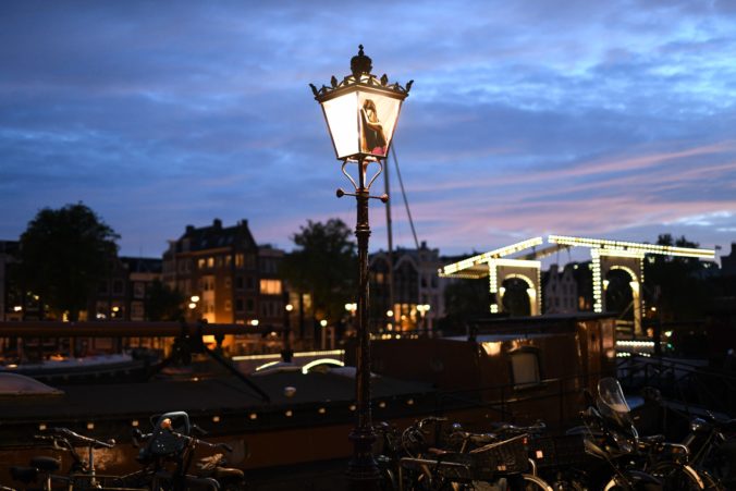 wide shot with Tape Art Sticker on street lamp in Amsterdam by artist Max Zorn