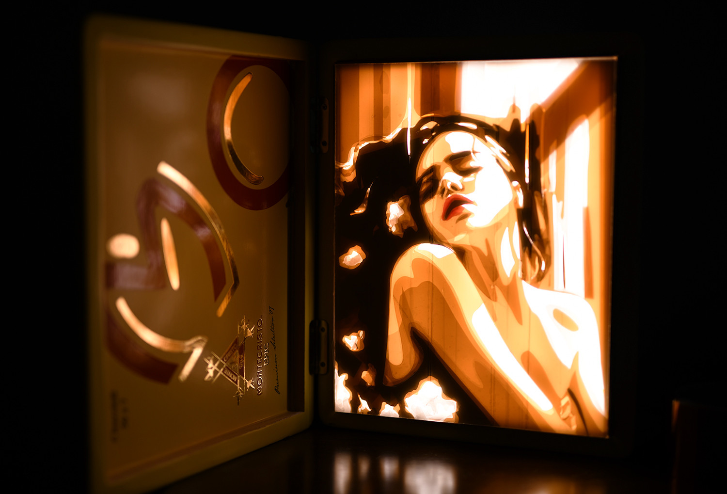 A captivating tape art piece by Max Zorn titled 'Nocturne', displayed in a LED-lit cigar box lightbox, highlighting a woman in a moment of contemplation.