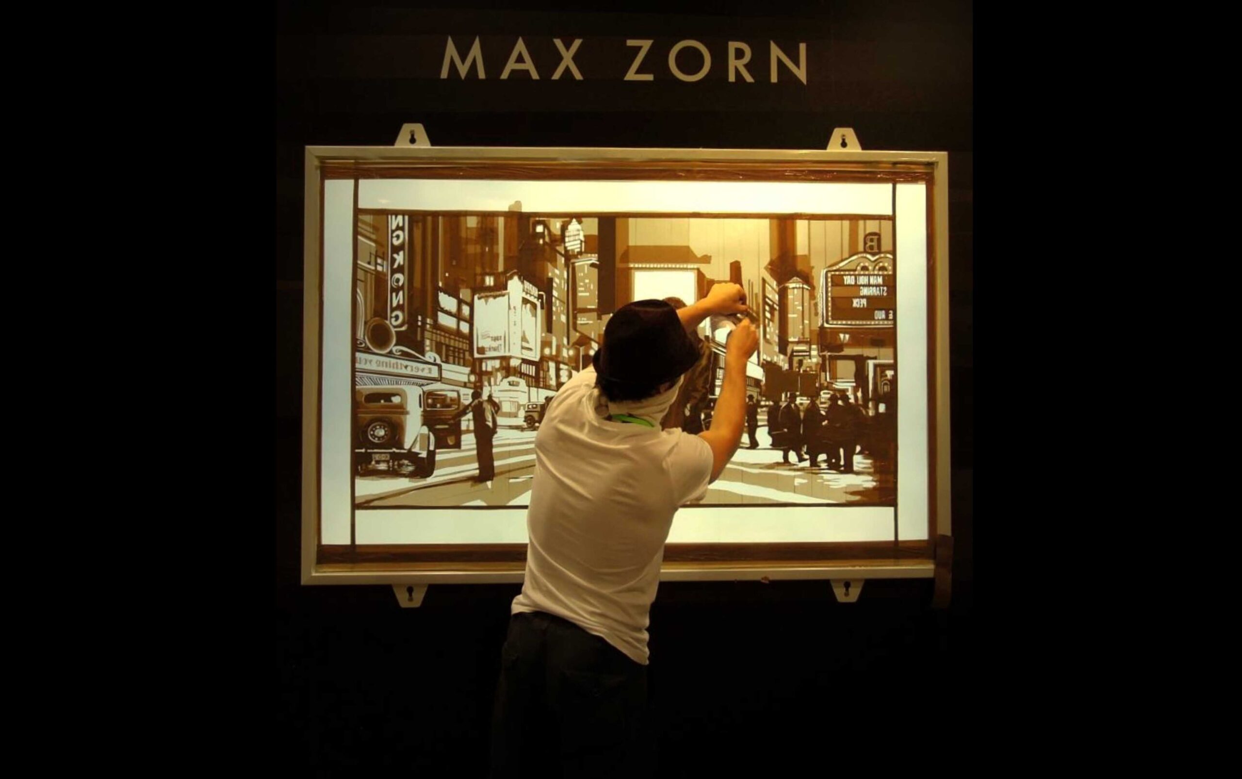 Artist Max Zorn applying brown packing tape on an illuminated acrylic panel to create a cityscape artwork at Art Basel Hong Kong 2011.