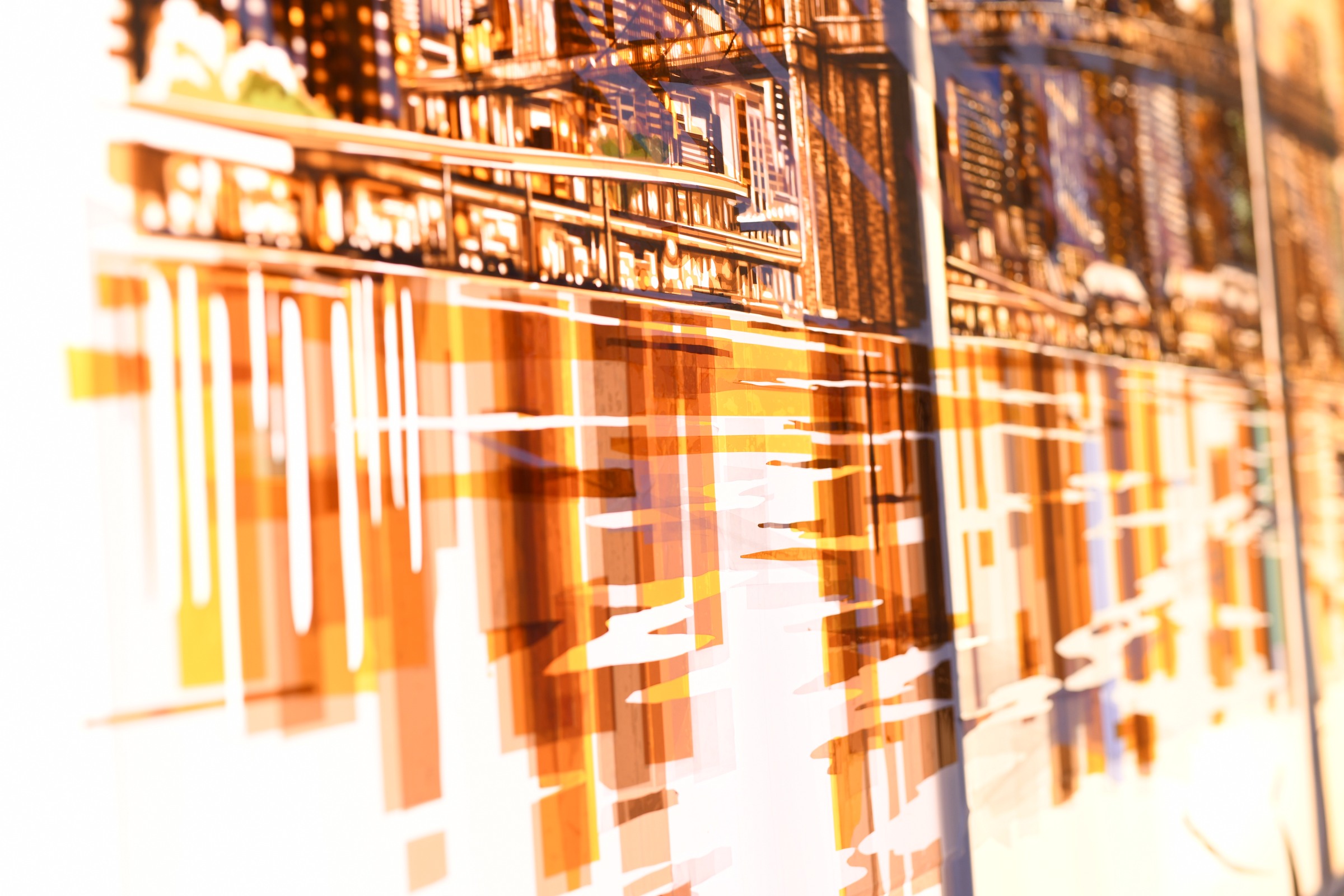 Close detail of Dream showing amber, white and blue tape shapes forming waterfront reflections below the New York skyline.