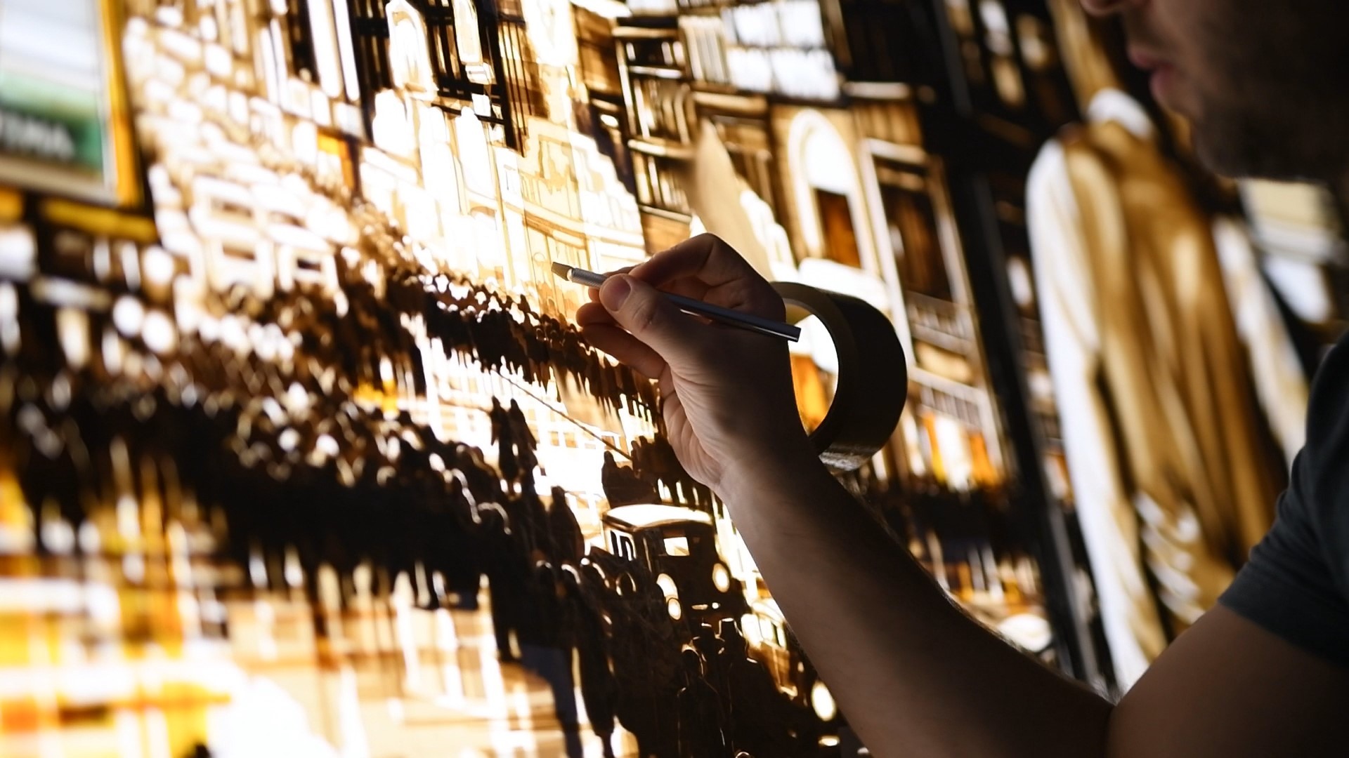 Max Zorn cuts fine details into the layered tape of Let them have the rest… with a precision knife.